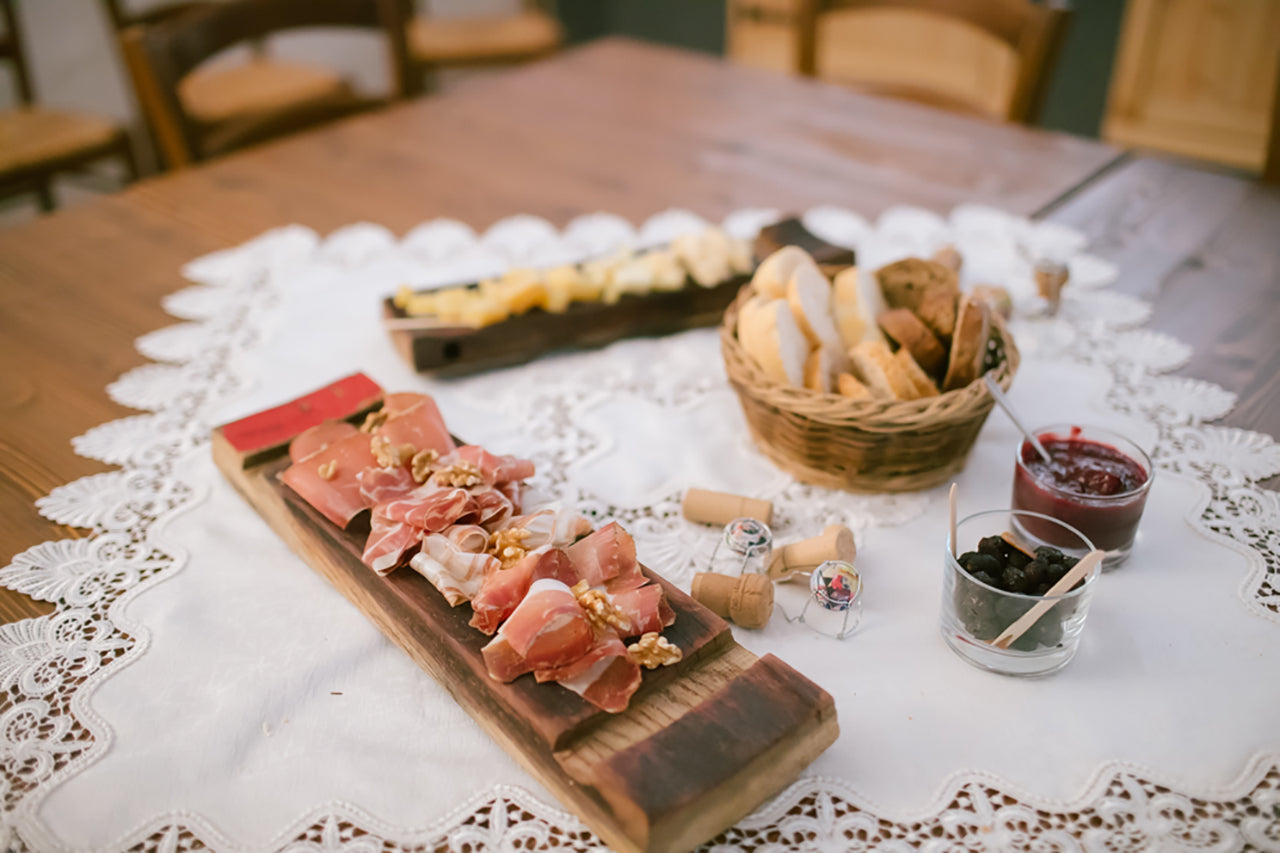 You can relax with an aperitif in a historic building with two glasses of wine, paired with local Trentino specialties such as Speck and Trentingrana cheese.